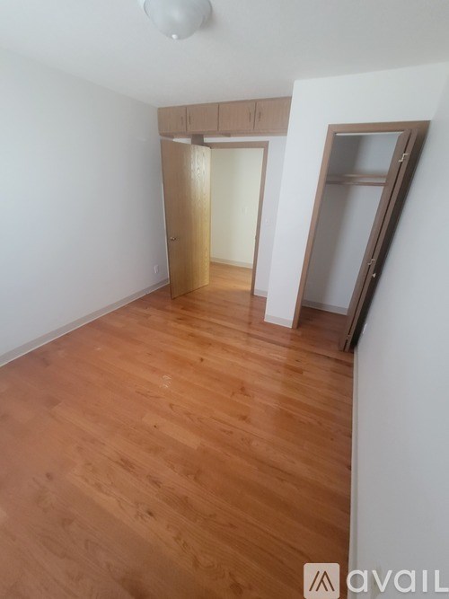 A room with wooden floors and white walls.