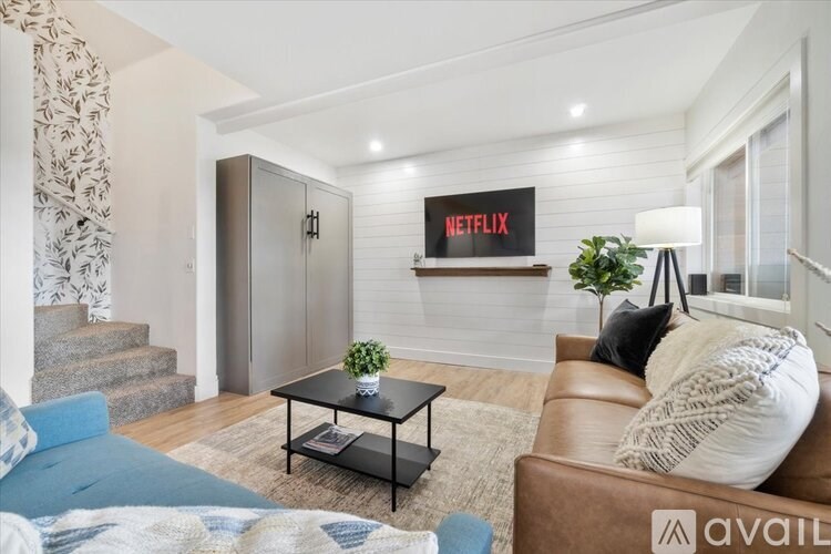 A living room with a Netflix sign on the wall.