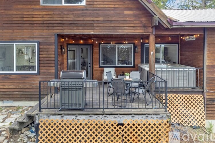 A wooden house with a balcony and a table set for two.