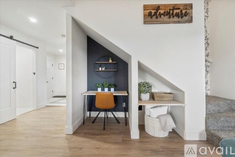 A room with a desk and a chair in it.