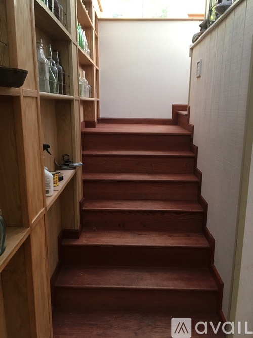 A staircase with a wooden banister and steps.