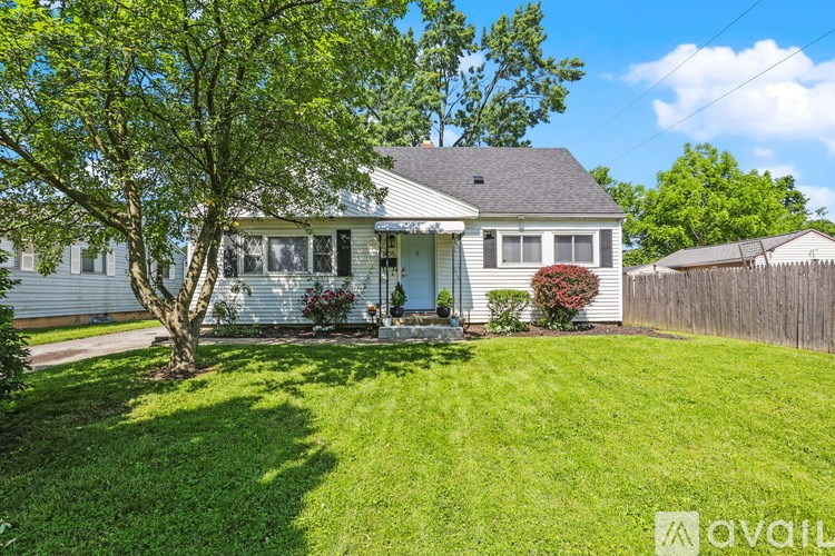 A house with a tree in front of it.