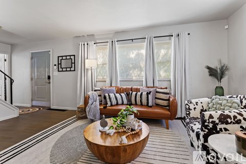 A living room with a brown coffee table and a brown couch.