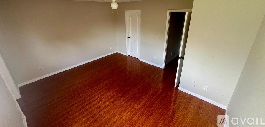 A room with wooden floors and white walls.