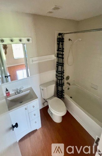 A bathroom with a toilet, sink, and bathtub.