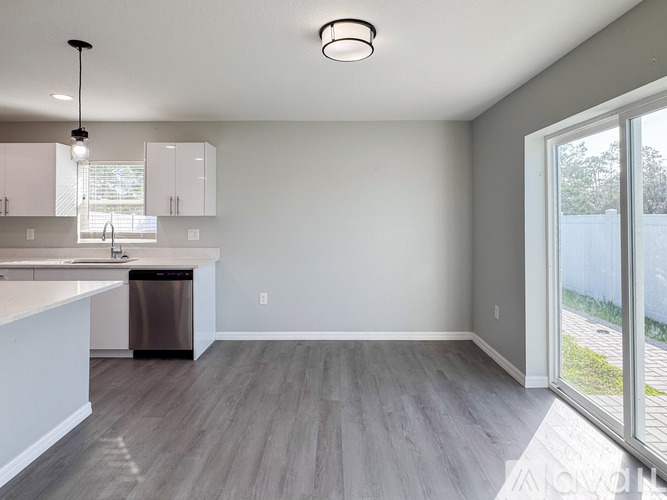 A modern kitchen with a dining table and chairs.