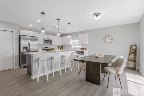 A modern kitchen with a dining table and chairs.
