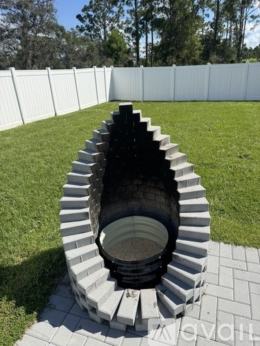 A white fence surrounds a black and white staircase.