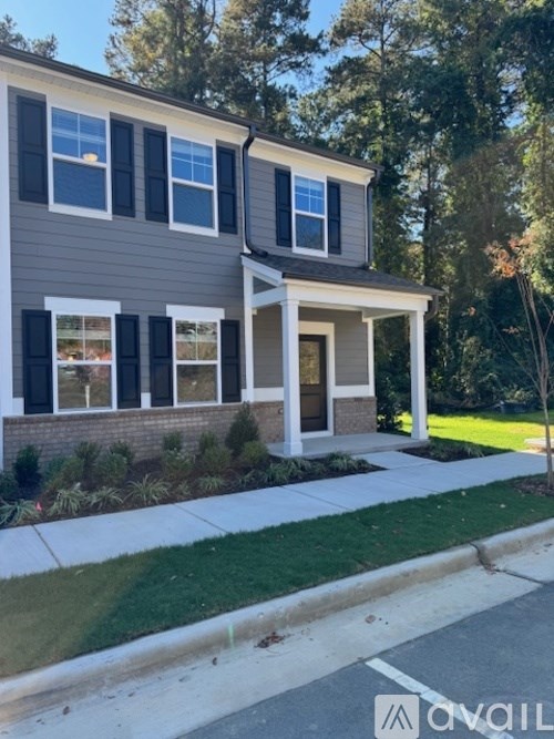 A house with a grey facade and white windows.