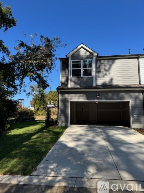 A two-story house with a garage and a driveway.