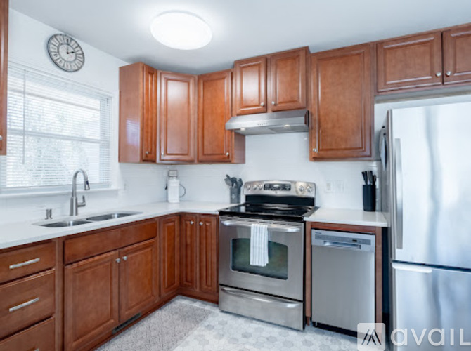A kitchen with wooden cabinets and stainless steel appliances.