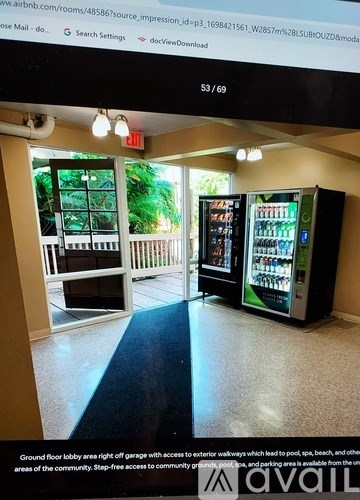 A room with a vending machine and a door leading outside.