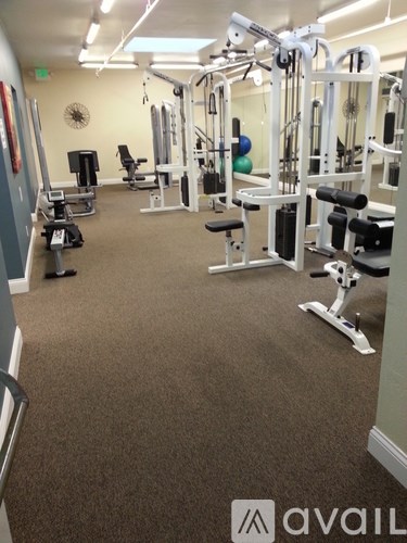 A gym with a variety of equipment including a leg press machine.