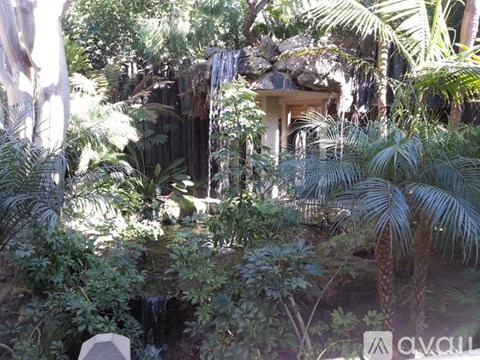 A small waterfall in a lush green garden.