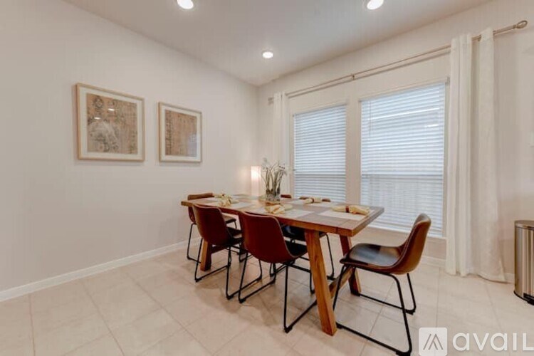 A dining room with a table set for four.