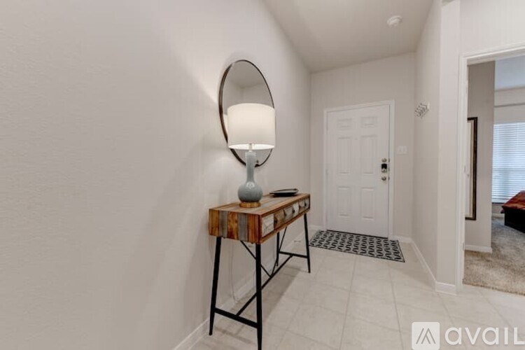 A lamp on a table in a room.