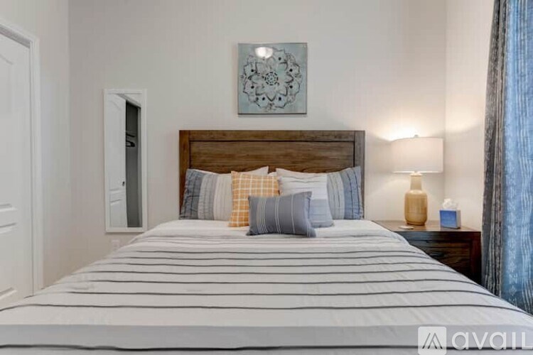 A bedroom with a large bed and a wooden headboard.