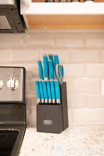 A set of blue and white knives in a holder on a kitchen counter.