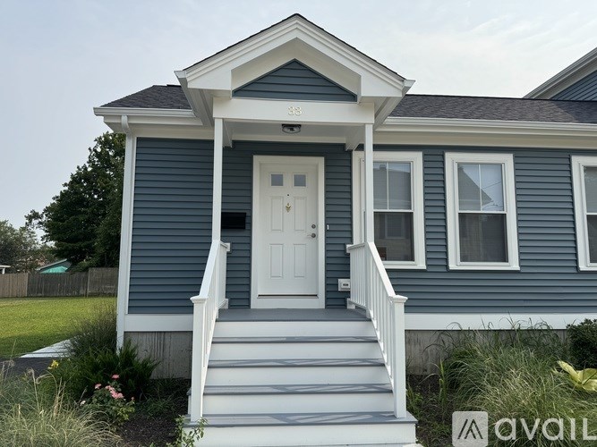 A blue house with a white door and windows.