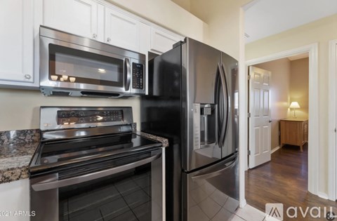 A kitchen with a black refrigerator and stove.