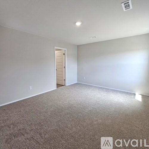 A room with a carpeted floor and a closed door.