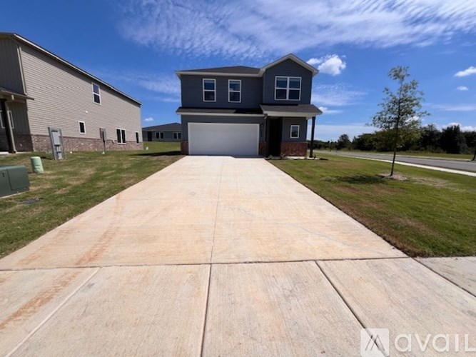 A house with a driveway in front of it is for sale.