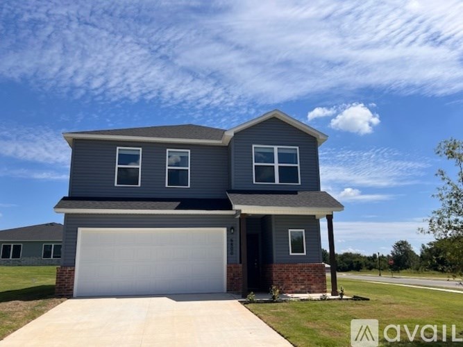 A two-story house with a garage is available for sale.