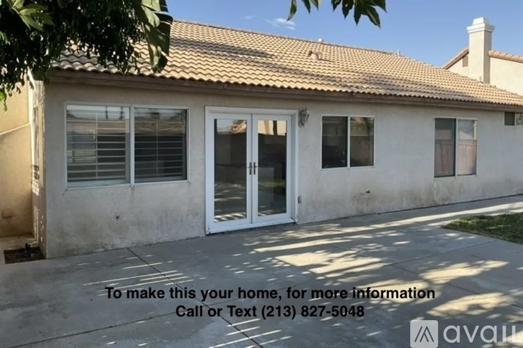 A house with a sign offering it for sale and a phone number.