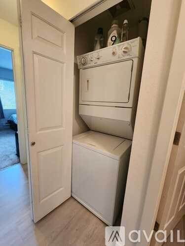 A white oven and dishwasher are built into a wall in a kitchen.