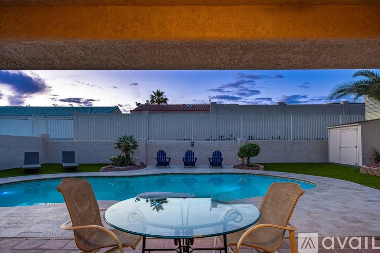 A backyard with a pool table and chairs.