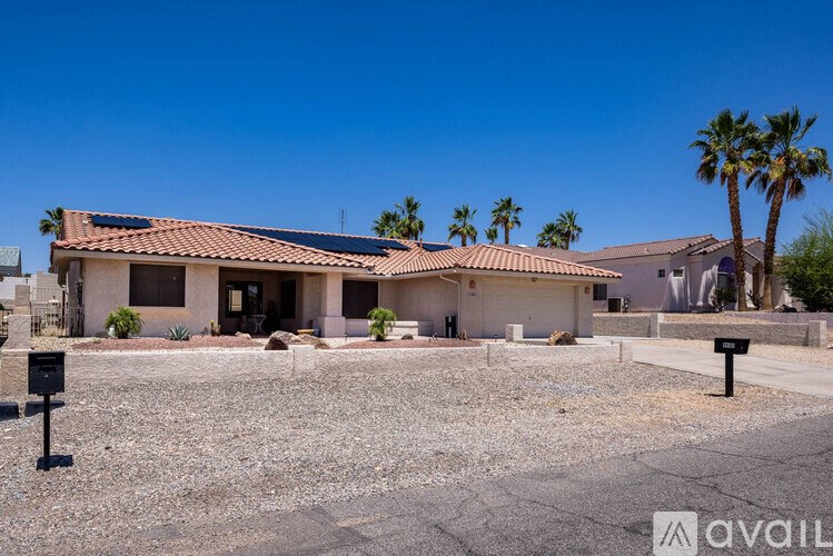 A house with a brown roof and a sign that says "available" in front of it.
