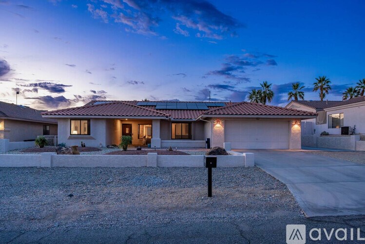 A house with a driveway and a sign that says "available" in front of it.