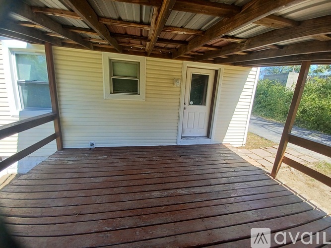 A wooden deck with a door and a window.