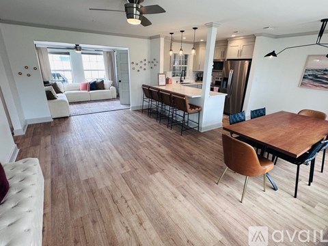 A living room with a dining table and chairs.
