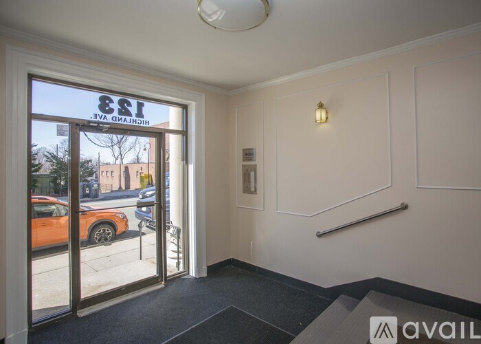 A view of a street through a glass door with a sign that reads "E&I" on it.