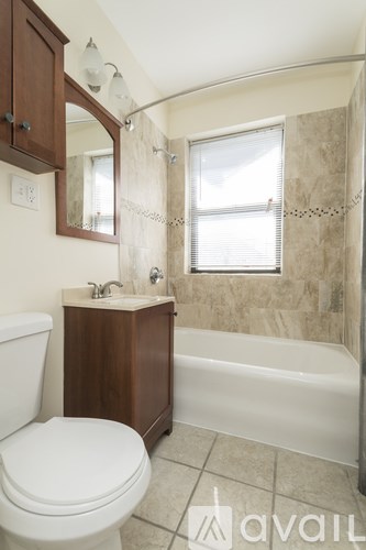 A bathroom with a toilet, sink, and bathtub.