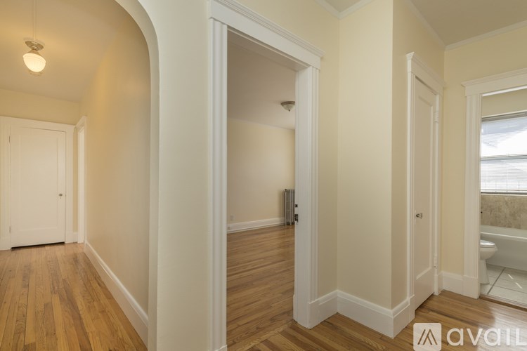 A room with wooden floors and white walls.