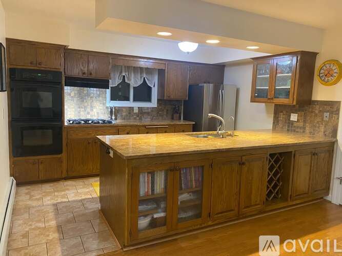 A kitchen with wooden cabinets and a granite countertop.