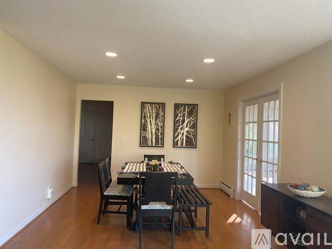 A dining room with a table set for four.