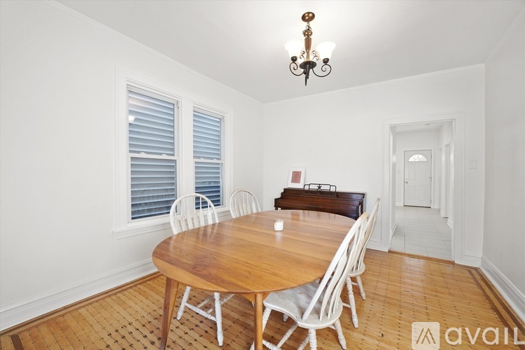 A kitchen with white cabinets and a stainless steel refrigerator.