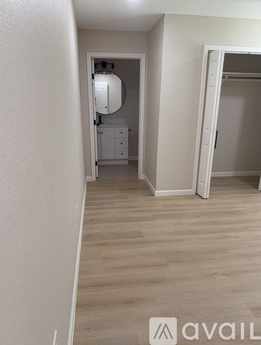 A room with a white door and a white cabinet with a light on it.