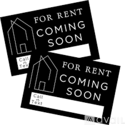 Two black and white signs that say "For Rent Coming Soon".