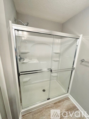 A white bathroom with a walk-in shower.