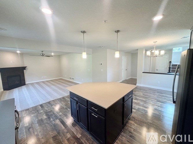 A spacious kitchen with a wooden floor and a large island.