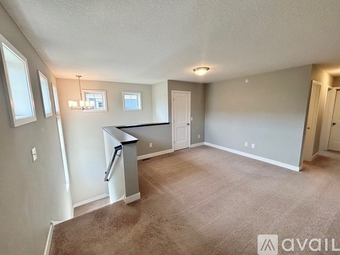 A spacious living room with a kitchenette and a bar area.
