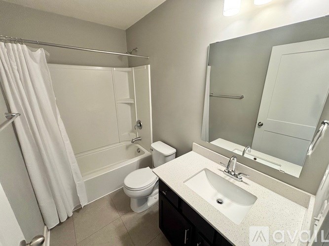 A bathroom with a toilet, sink, and bathtub.