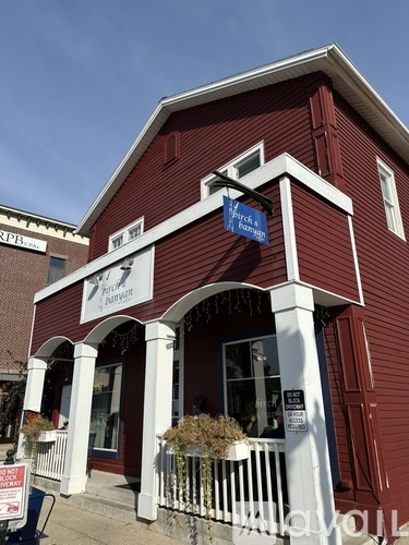 A red building with a white porch and a sign that says "Foren & Benecke".