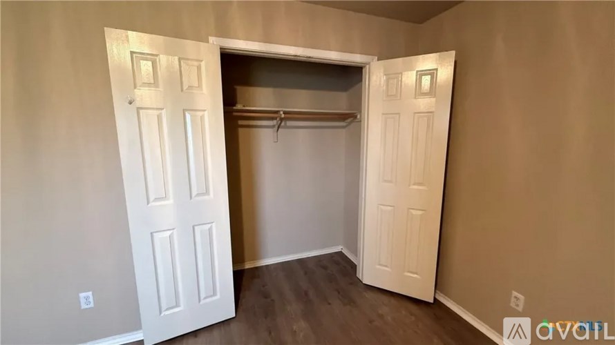A room with a white door and a coat rack.