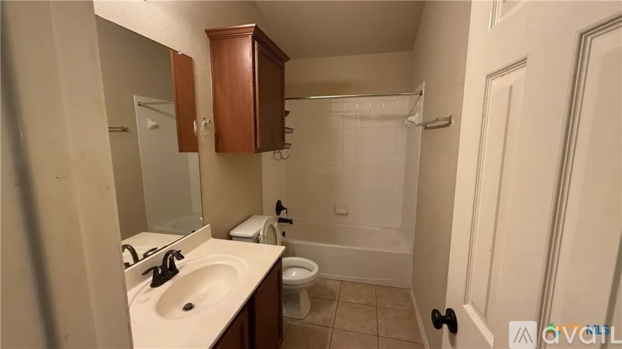 A bathroom with a sink, toilet, and shower.