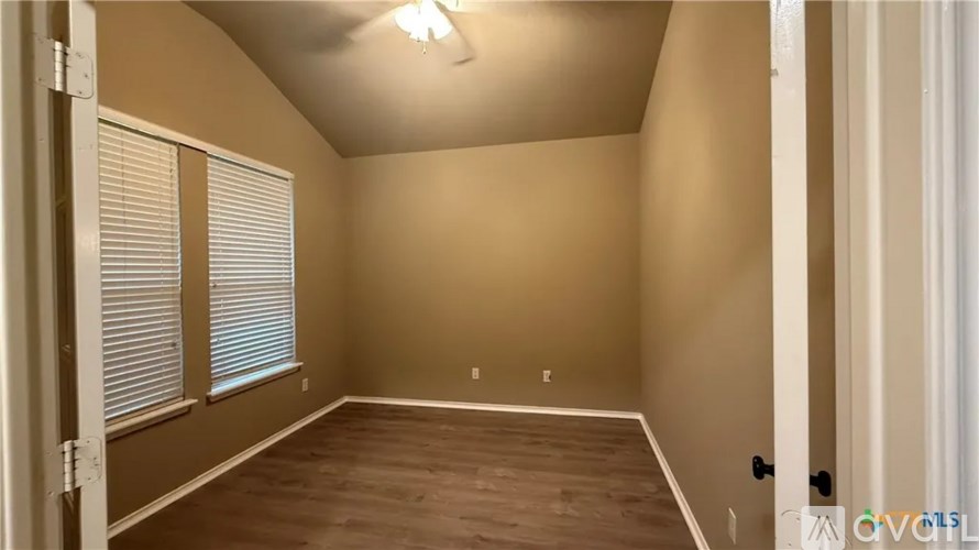 A room with brown walls and a wooden floor.